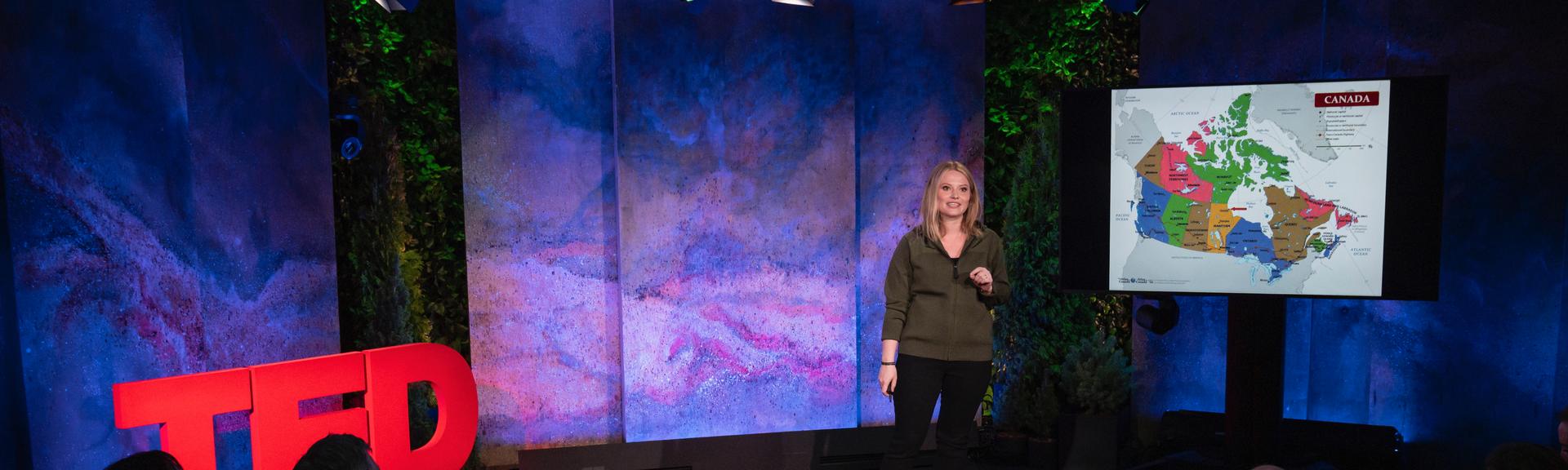 Alysa McCall gives a TED talk on the TED stage.