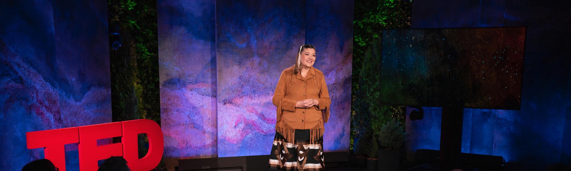 Matricia Bauer gives a TED talk on the TED stage.